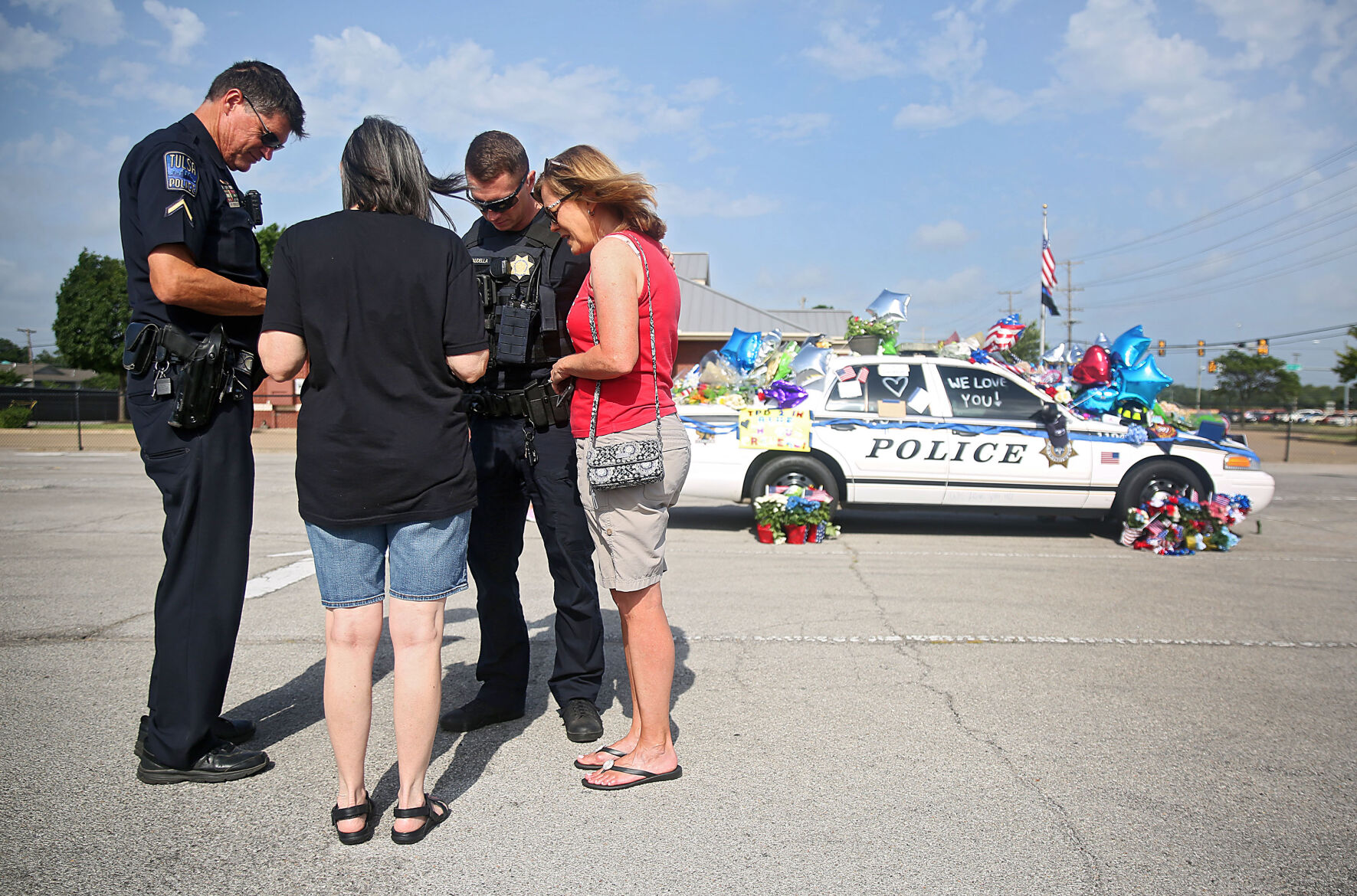 A parked police car becomes a symbol of Tulsa's support for officers who were shot
